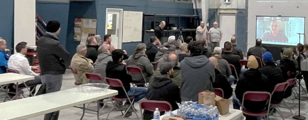 Above) WMCO member look on as Mike Clare and Rob Clare provide opening remarks to the plant tour