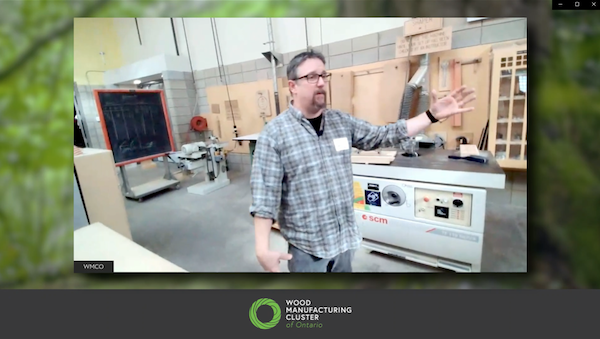 Drew Aaslepp, Humber College Woodworking Program Coordinator hosting a tour of the woodworking shop. Machinery in the background looks new and well maintained.